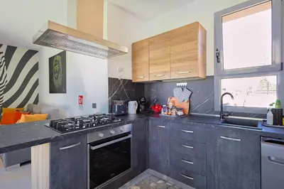 a kitchen with a stove top oven next to a window at Dimora Masi di GN Real Escapes in Castellammare del Golfo