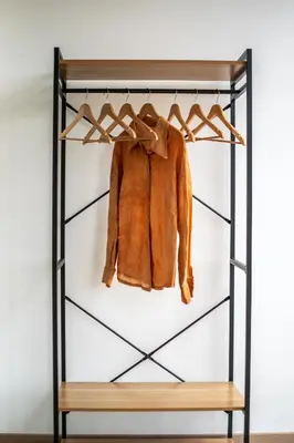 a closet with a coat hanging on a rack at Politeama Crystal Rooms in Palermo