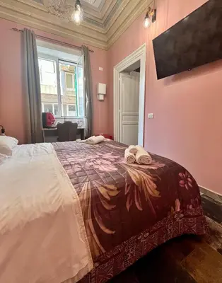 a bedroom with a bed with two towels on it at B&B Dimora Emily in Palermo