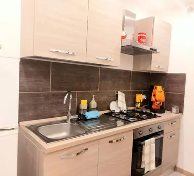 a kitchen with a sink and a stove at Murriali Apartment in Monreale