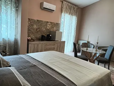 a bedroom with a bed and a table and chairs at Dojo idro rooms in Carini