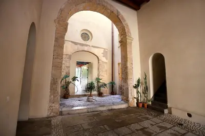 an archway in a building with potted plants in it at Oasi Porta Felice in Palermo