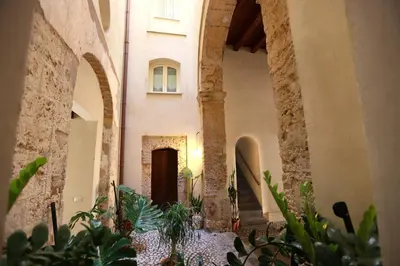 an alley way with plants in a building at Oasi Porta Felice in Palermo