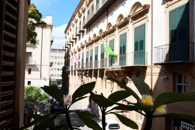 a bird sitting on a balcony of a building at Oasi Porta Felice in Palermo