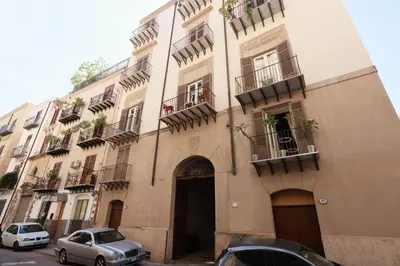 a building with cars parked in front of it at Oasi Porta Felice in Palermo