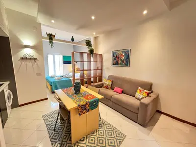 a living room with a couch and a table at Teatro Massimo - Apartment with a View of Teatro Massimo in Palermo
