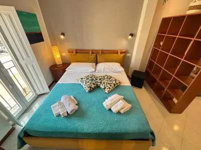 a bedroom with a bed with two towels on it at Teatro Massimo - Apartment with a View of Teatro Massimo in Palermo