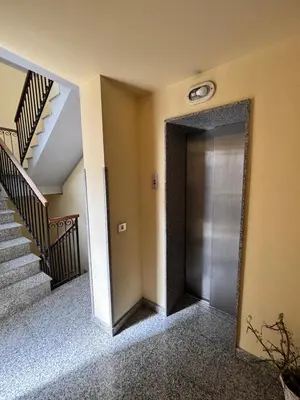 a hallway with a metal door and stairs at Teatro Massimo - Apartment with a View of Teatro Massimo in Palermo
