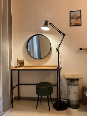 a desk with a mirror and a lamp and a stool at Backpackers House - Ballaró in Palermo