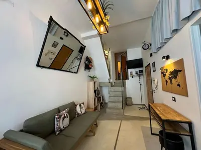 a living room with a couch and a mirror on the wall at Backpackers House - Ballaró in Palermo