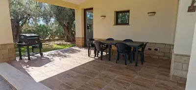 a patio with a table and chairs and a grill at Villa Samay Luxury House in Carini