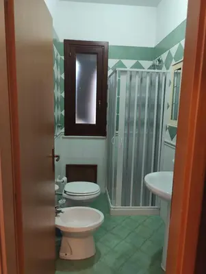 a bathroom with a toilet and a sink and a shower at Appartamento Gelsomino in San Vito lo Capo