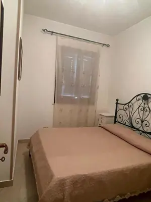 a small bedroom with a bed and a window at Appartamento Giglio in San Vito lo Capo