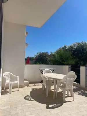 a white table and chairs on a patio at Appartamento Giglio in San Vito lo Capo