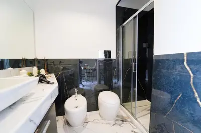 a bathroom with a sink and two white vases at Quattro Canti 200 mt- Appartamento Salvia in Palermo