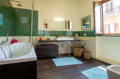 a bathroom with a tub and a sink at Central Panoramic View in Palermo
