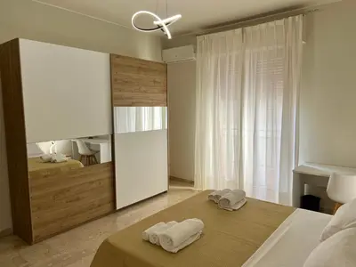 a bedroom with two towels on a bed with a mirror at Dantes House in Palermo