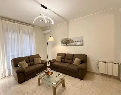 a living room with two couches and a table at Dantes House in Palermo