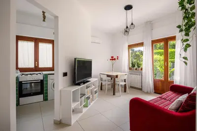 a living room with a tv and a red couch at More Holidays Beach in Mondello