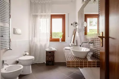 a bathroom with two toilets and a tub and a sink at More Holidays Beach in Mondello