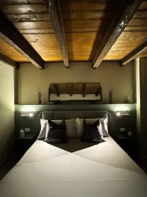 a bedroom with a large white bed with two pillows at Loft Cattedrale Palermo in Palermo