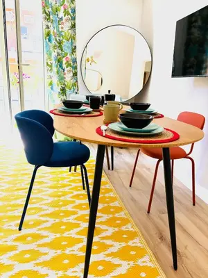 a dining room table with a mirror and two chairs at Centrale e accogliente Casa Papèl in Palermo