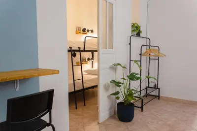 a black chair and a plant in a room at Casabra in Palermo