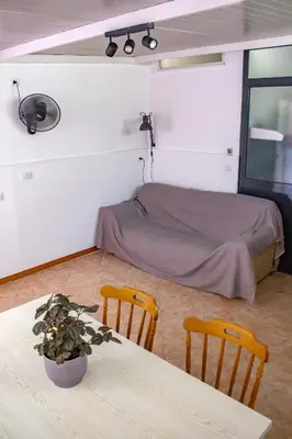 a room with a bed and a table and chairs at Casabra in Palermo