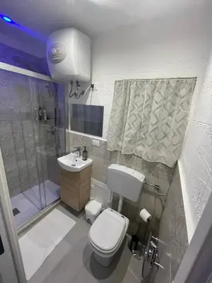 a bathroom with a toilet and a shower and a sink at La Casetta di Lussy in Palermo
