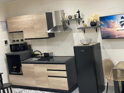 a kitchen with a stove and a refrigerator at La Casetta di Lussy in Palermo