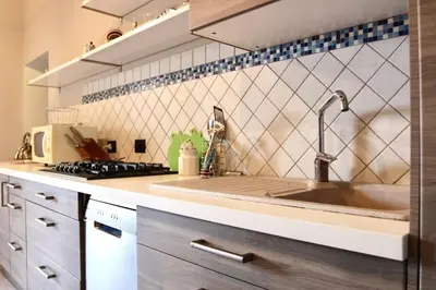 a kitchen with a sink and a stove at Villa Enza Bellissima villa con piscina in Terrasini