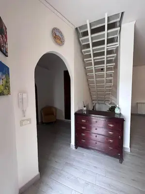 a room with a wooden dresser and an archway at Villa Mia Mondello, 200m to beach, private parking in Palermo