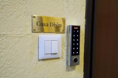 a sign on a wall with a switch at Casa Disìu in Palermo
