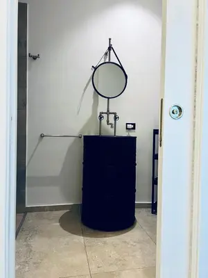 a mirror sitting on a stand in a room at Guest House Colonna apt in Palermo