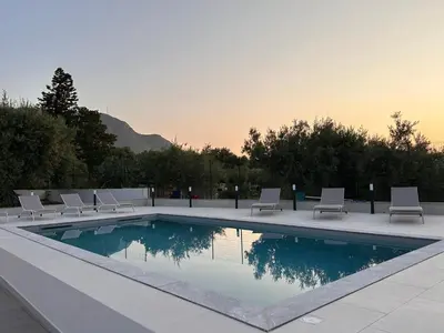 a swimming pool with lounge chairs next to at Villa Valentina in Altavilla Milicia