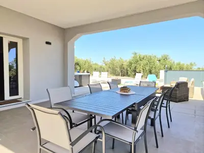 a blue table and chairs on a patio at Villa Valentina in Altavilla Milicia