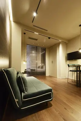 a living room with a couch and a table at Di fronte a Suite in Palermo