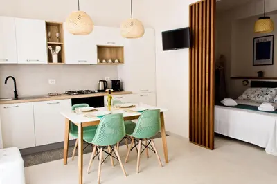 a kitchen with a table and chairs in a room at Verdeacqua Home in Castellammare del Golfo