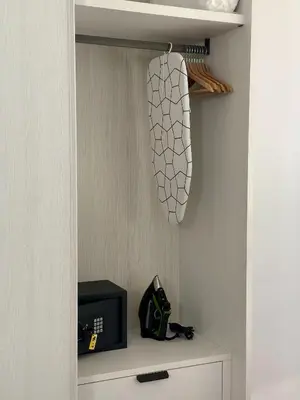 a closet with a shelf with a clock and a drawer at Nika Palermo Holiday House in Palermo