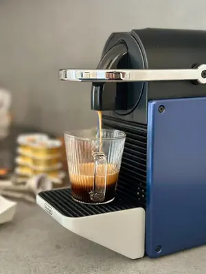 a coffee maker is making a cup of coffee at Nika Palermo Holiday House in Palermo
