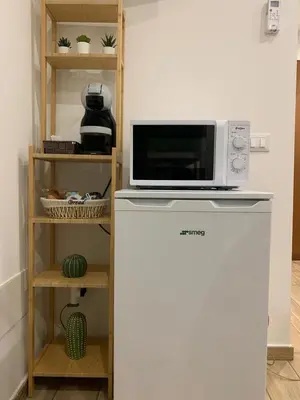 a microwave sitting on top of a refrigerator at Profumi di Sicilia in Cinisi