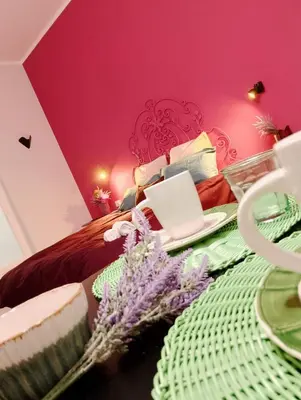 a bedroom with a bed with a pink wall at Le case di Caterina in Palermo