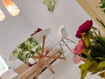 a living room with chairs and a plant at Le case di Caterina in Palermo
