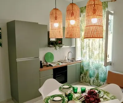 a kitchen with two chandeliers and a table in a kitchen at Le case di Caterina in Palermo