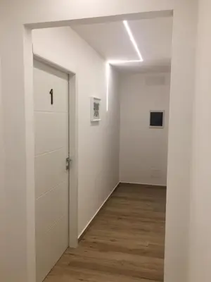 an empty room with a door and a hallway at La Zisa Luxury Apartment in Palermo