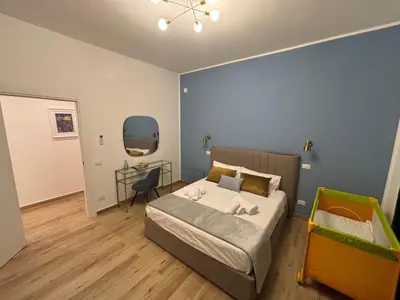 a bedroom with a bed and a desk in it at La Zisa Luxury Apartment in Palermo