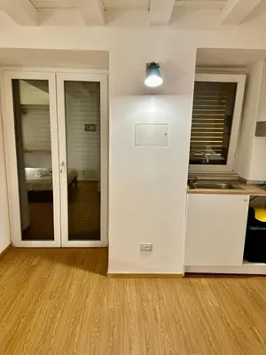 an empty room with a kitchen and a counter at Cala Peppa Apartments in Palermo