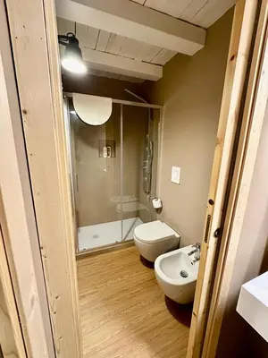 a bathroom with a shower and a toilet and a sink at Cala Peppa Apartments in Palermo