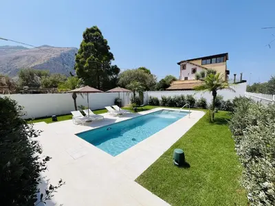 a villa with a swimming pool and a house at Marina Boutique Rooms in Carini