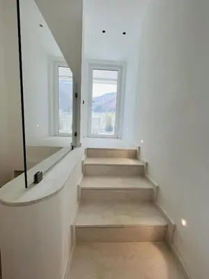 a staircase in a white room with two windows at Marina Boutique Rooms in Carini